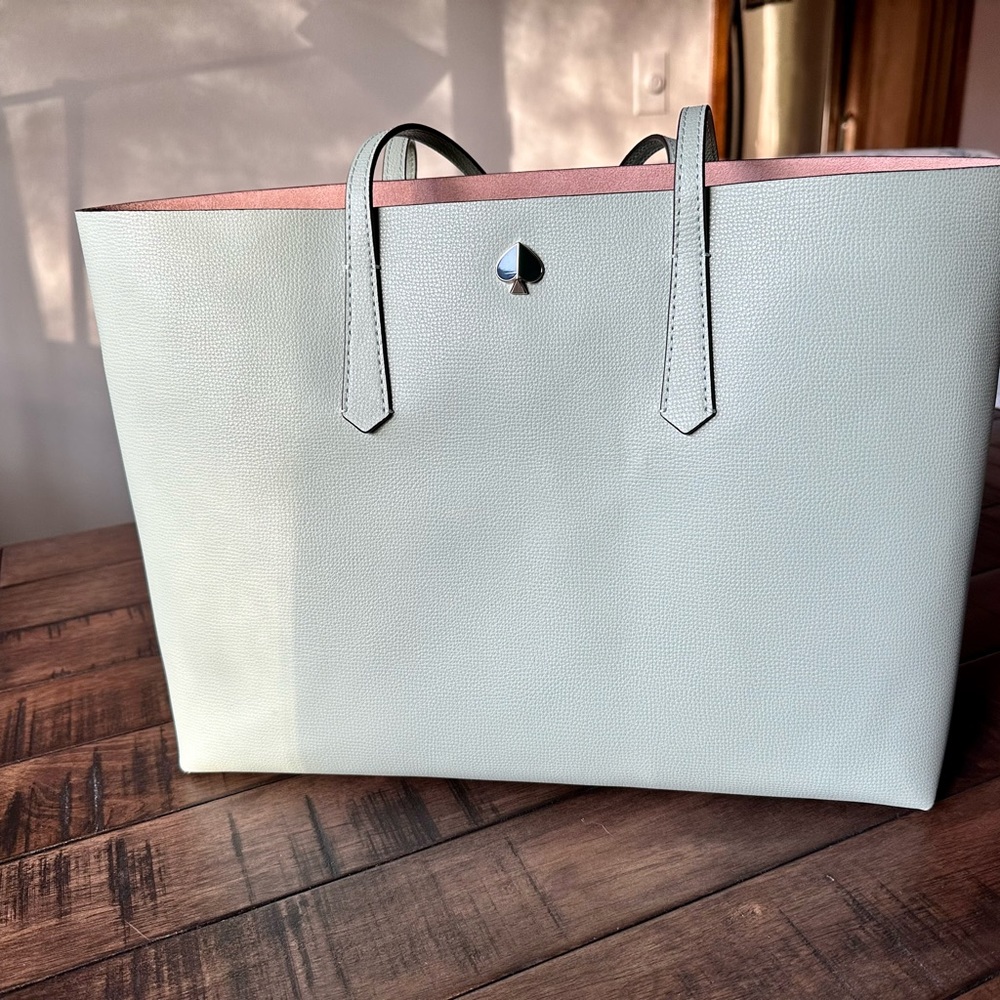 Large Kate Spade leather tote with matching zipper pouch.